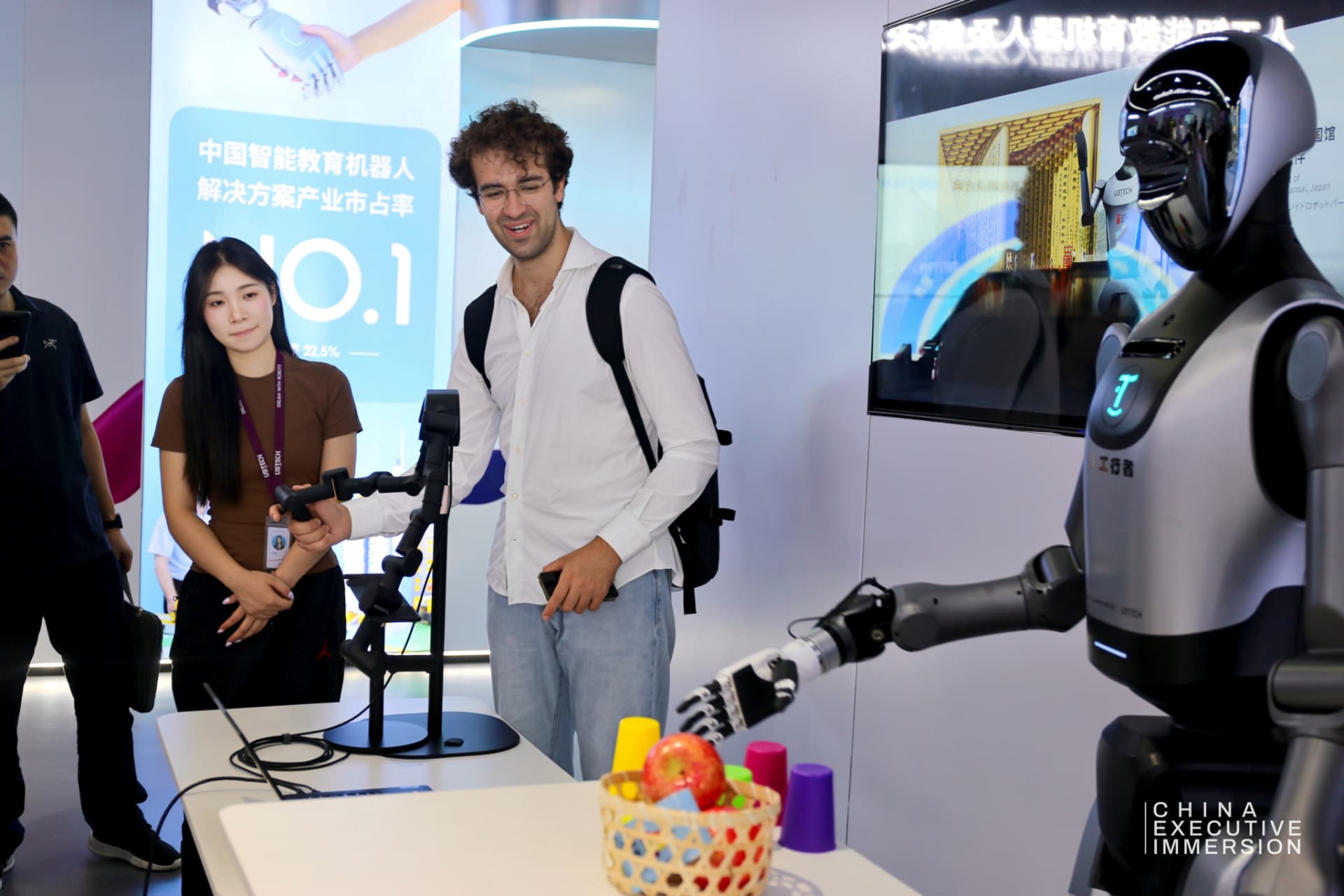 UBTECH — a delegate driving the robot arm through the teleoperation rig — Shenzhen